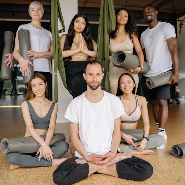 Group of diverse people sitting calmly on yoga mats indoors