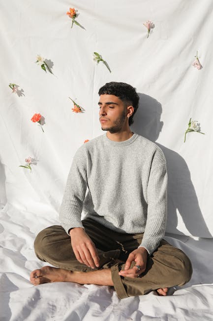Happy and serene person meditating by a large sunlit window