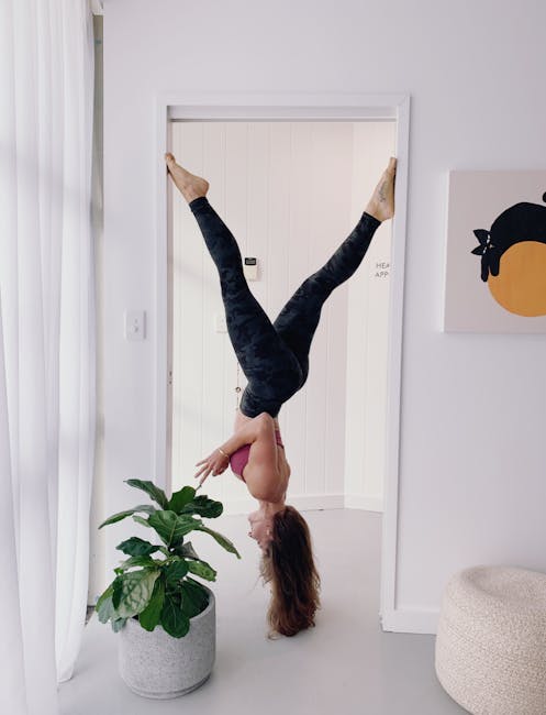 Woman in a graceful yoga pose against a minimal bordeaux background